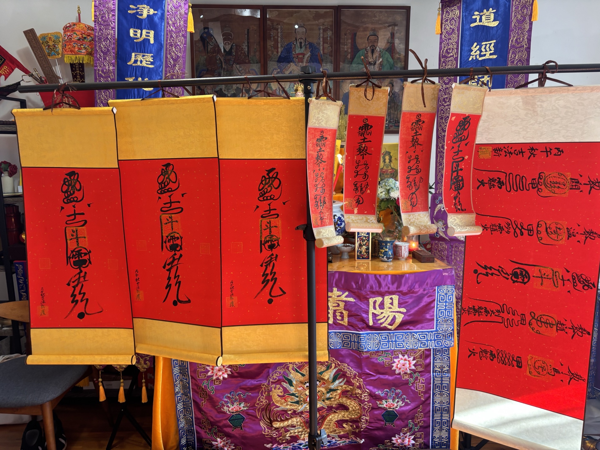 Red and gold Taoist talisman scrolls displayed at Yangzhu